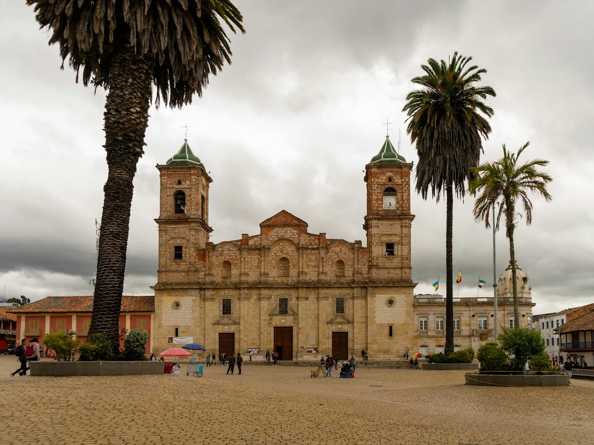 The Diocesan Cathedral of Zipaquirá's twin bell towers on the town's main square, framed by palm trees